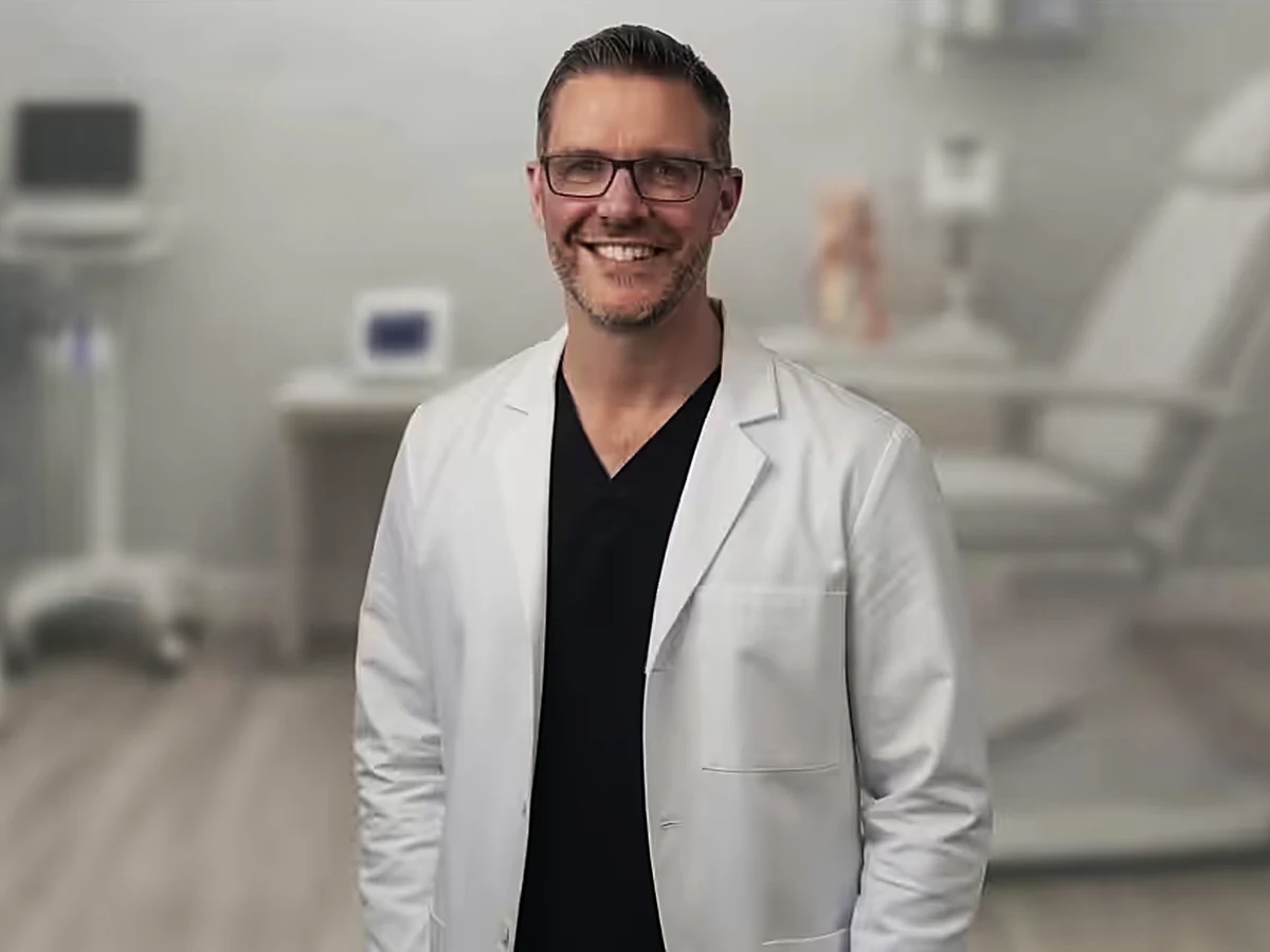 Dr. Tom Biernacki, DPM, FACFAS, standing in his foot and ankle clinic exam room