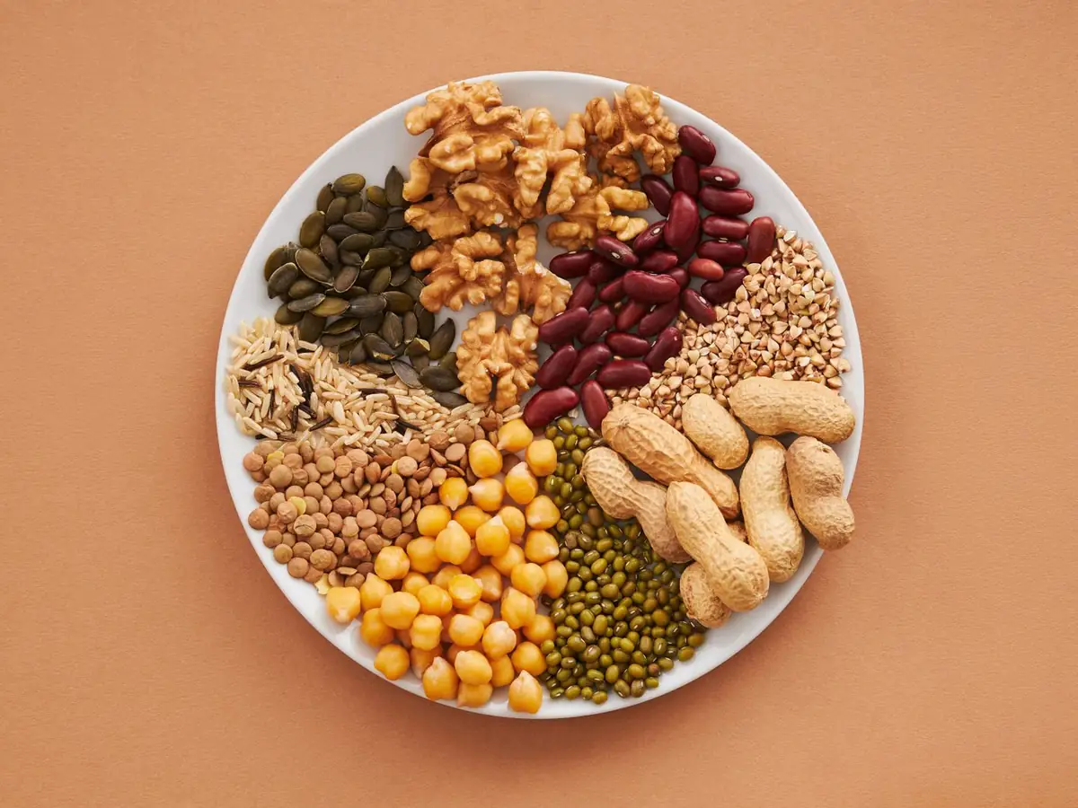 A plate of walnuts, pumpkin seeds, peanuts, beans, lentils, chickpeas and whole grains, all sources of magnesium